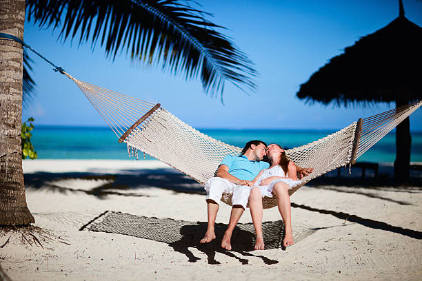 istock Romantic couple relaxing in hammock 119486127