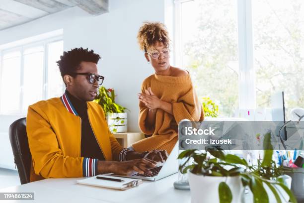 Colleagues Working Together On A New Project Stock Photo - Download Image Now - 30-34 Years, Adult, Adults Only