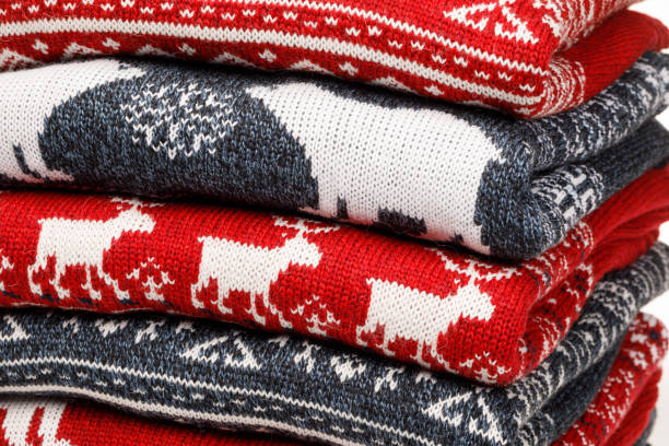 istock Stack of folded knitted Christmas turtleneck sweaters closeup 1194861962