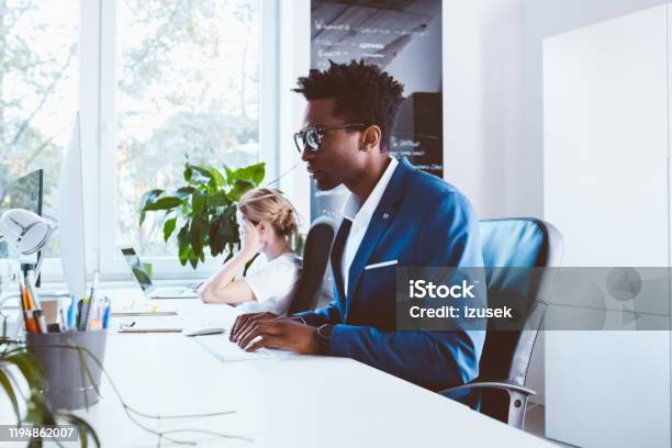 Businessman Busy Working In Office Stock Photo - Download Image Now - 30-34 Years, Adult, African Ethnicity
