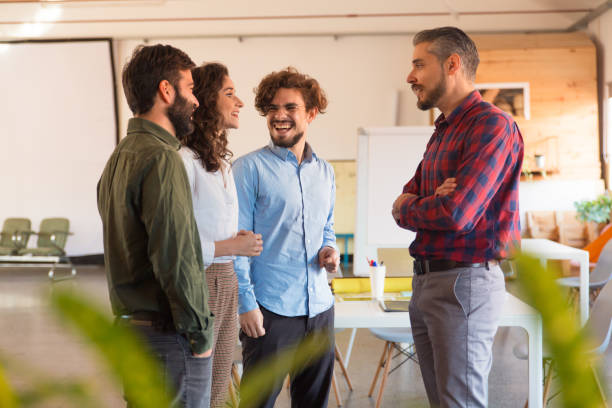 istock Creative group reporting to team leader and laughing 1194865527