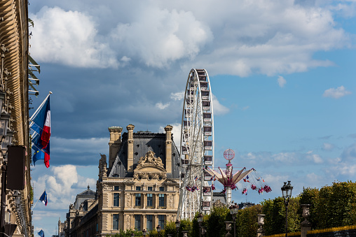 The Paris Ferris Wheel  on the Place de la Concorde Louvre Museum at the right bank of Seine Rive, the world's largest art museum and a historic monument in Paris, France.