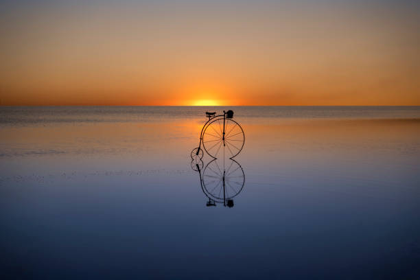 istock retro bicycle on the lake at sunset. 1194867250