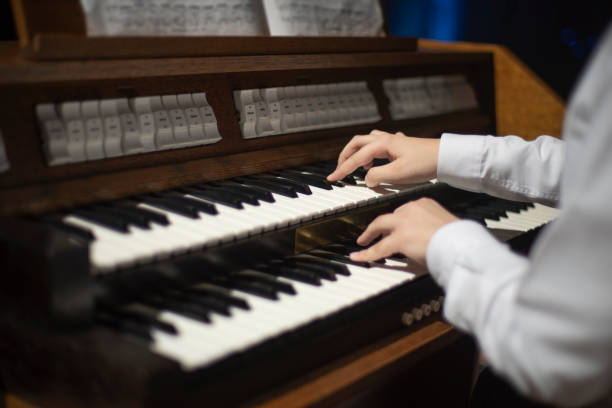istock hands play on the organ. 1194868335