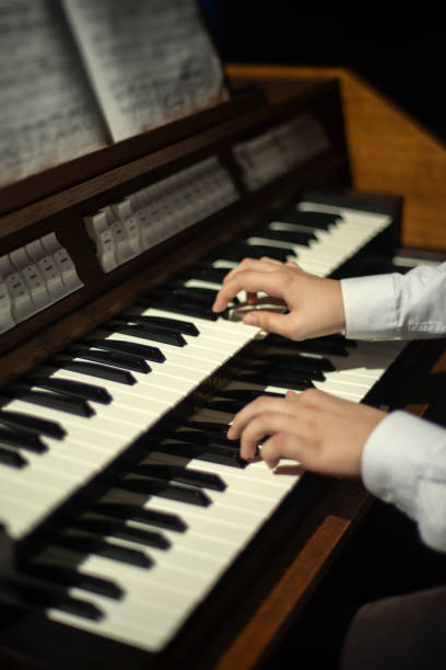 istock hands play on the organ. 1194868336