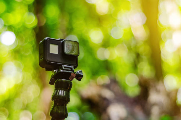 istock Action camera on a flexible tripod on green forest background 1194870844