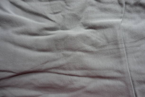 istock Rumpled light grey cotton fabric from above 1194871037