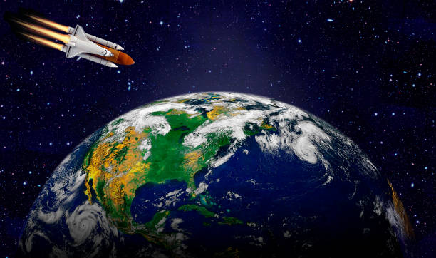 istock Space shuttle orbiting Earth planet. Elements of this image furnished by NASA 1194871158