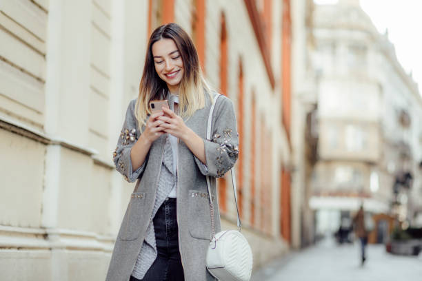 istock Pretty young woman using a phone 1194873464