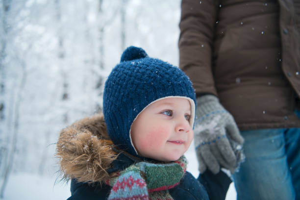 istock Happy family walking in winter forest 1194874425