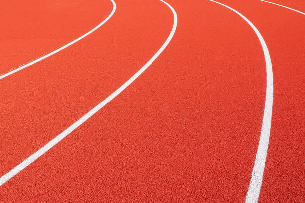 istock Curved white lines on a red running track 1194879399