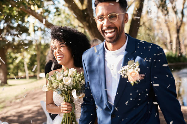 We've made so many special moments today Shot of a happy newlywed young couple getting showered with confetti outdoors on their wedding day newlywed photos stock pictures, royalty-free photos & images