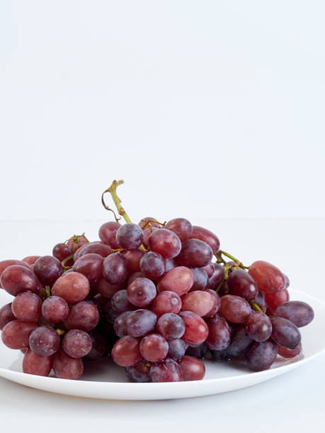istock Grapes on white plate. Vitamin c food. 1194883560