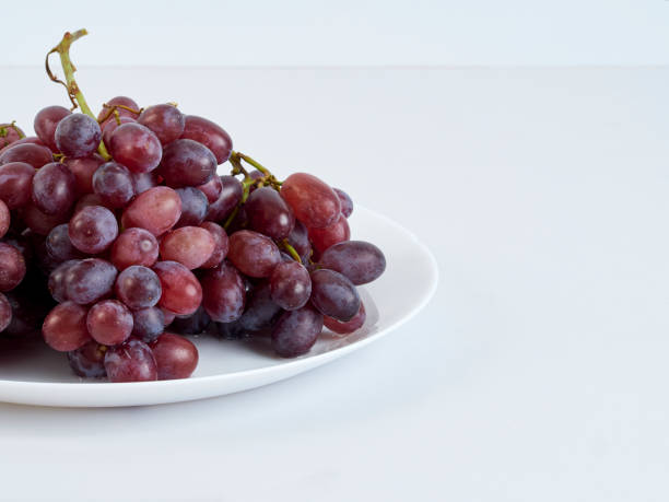 istock Grapes on white plate. Vitamin c food. 1194883566