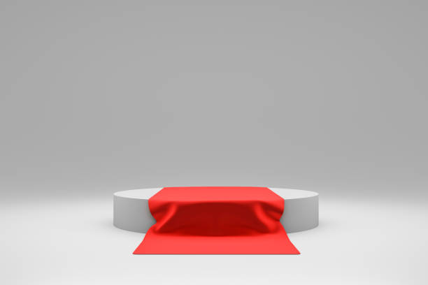 istock Modern pedestal or podium display with red fabric platform concept on white background. Blank shelf stand for showing product. 3D rendering. 1194885790
