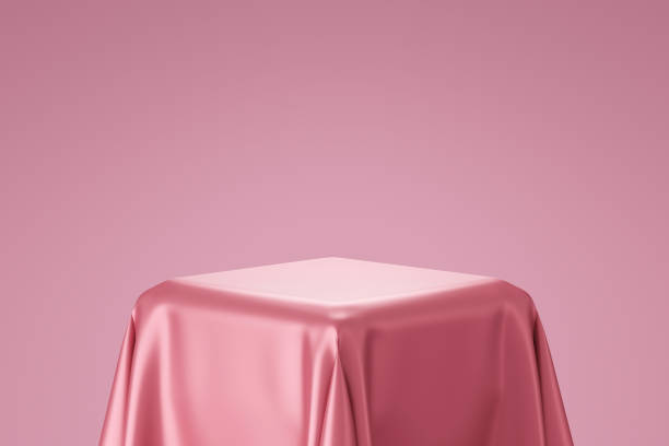 Pink pedestal or podium display with satin fabric platform concept on valentines background. Blank shelf stand for showing product. 3D rendering.