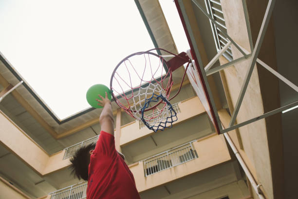 istock Asian boy slam dunk with balloon 1194886324