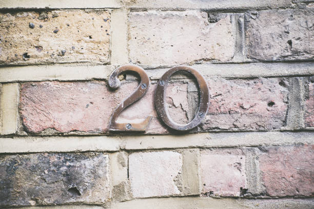 The twenty house number placed on the brick wall.