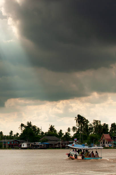 istock Dramatic rainstorm over a ferryboat on Chao Phraya River. 1194886547