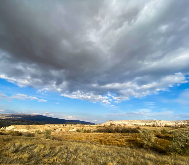 istock View of a valley filled with ancient rock formations. Blue sky, white clouds. Cappadocia, Turkey. 5 november 2019 1194886592