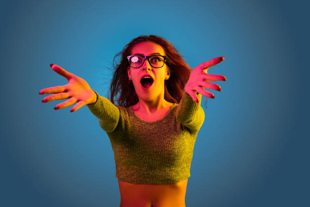 istock Caucasian woman's portrait isolated on blue studio background in neon light 1194886824
