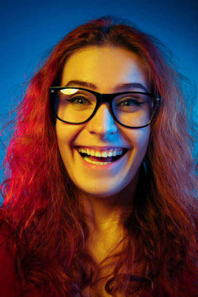istock Caucasian woman's portrait isolated on blue studio background in neon light 1194886953