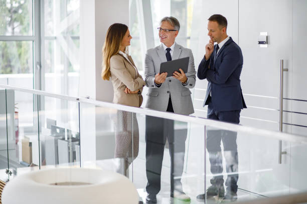 istock Group of mixed aged business people collaborating over digital tablet 1194888147