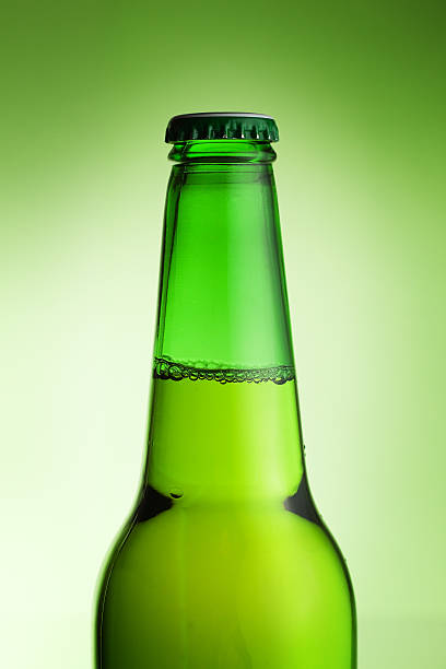 istock beer bottle over green background 119488957