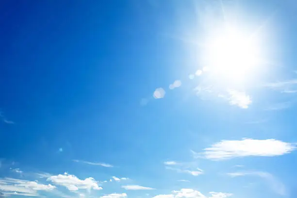 Photo of bright blue sky with the sun causing lens flare
