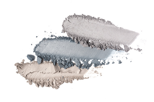 Brush stroke of crushed gray eye shadow as sample of cosmetic product isolated on white background
