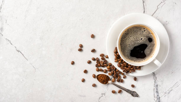 Top view of black coffee in white cup with sugar for breakfast