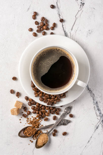 istock Top view of black coffee in white cup with sugar for breakfast 1194890265