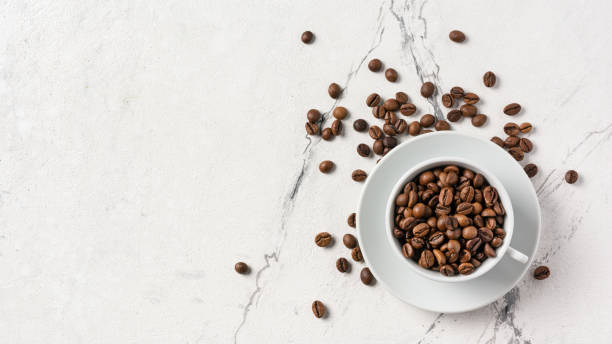 istock Top view of coffee beans in white cup for breakfast 1194890332