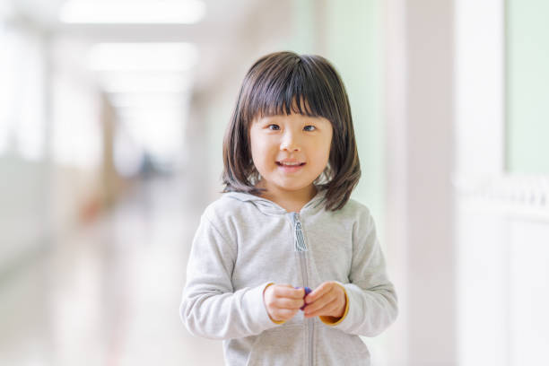 portrait of small school girl in hallways - japanese girl imagens e fotografias de stock
