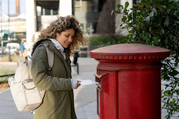 istock Woman in London posting a letter 1194895536