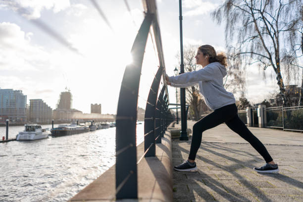 istock Woman outdoors stretching before her morning run 1194895544