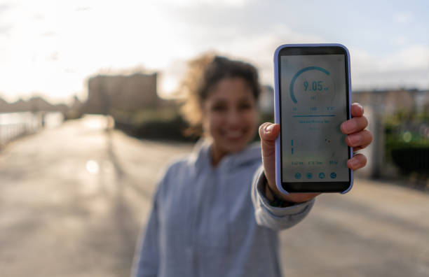 Woman tracking her fitness progress on an app while running