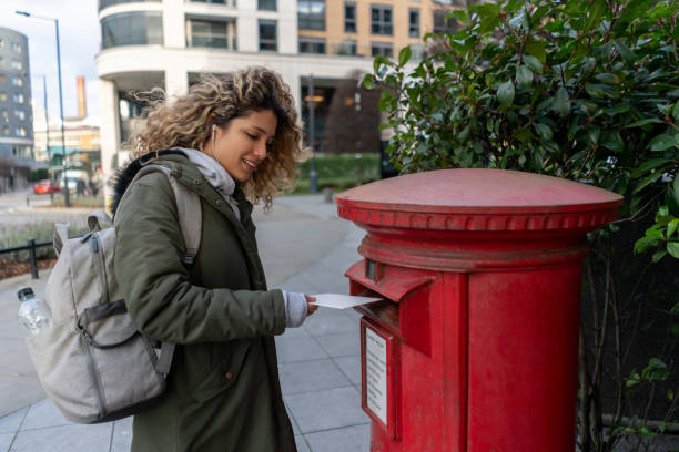 istock Woman posting a letter in the mail 1194895602