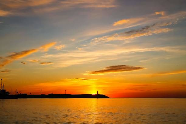 istock Sunrise in Malaga, Spain. Lighthouse on the horizon 1194895872