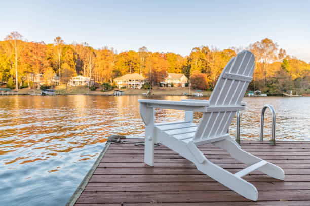 istock Adirondack style chair on a dock, overlooking a lake 1194896878