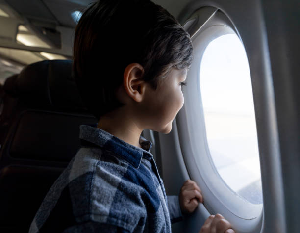 istock Excited little boy looking at the window view during a commercial flight 1194896953