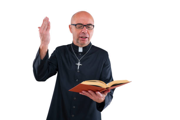Priest blessing hand preaching with bible and cassock isolated on white