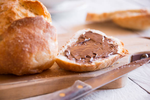 istock Sliced loaf of wheat bread with peanut butter for breakfast 1194897234