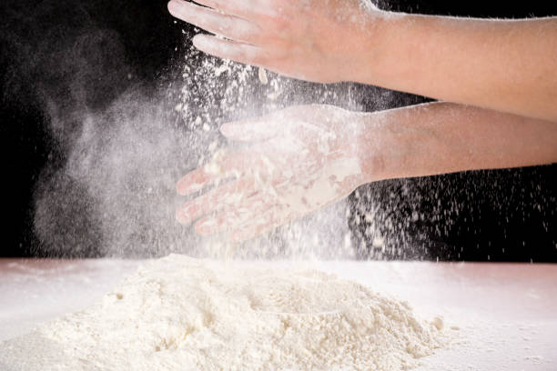 istock chef's hand clapping with powder flour when kneading the dough 1194897898