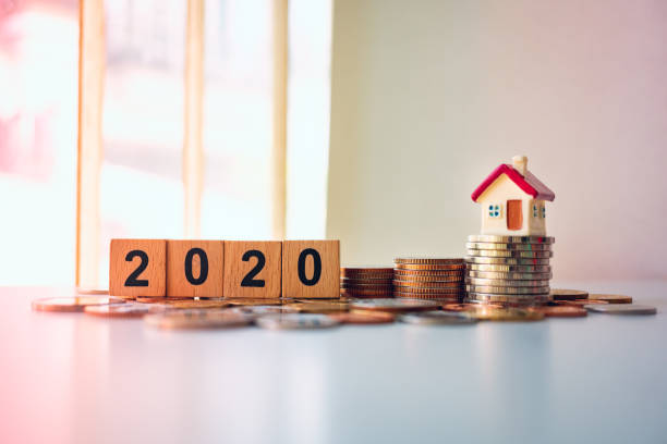 istock Wooden block year 2020 and mini house 1194898393