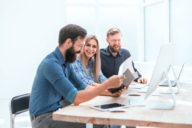 istock group of business people discussing financial documents 1194899517