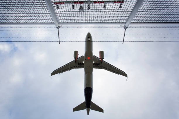 istock Low-angle view of a landing airplane 1194900992
