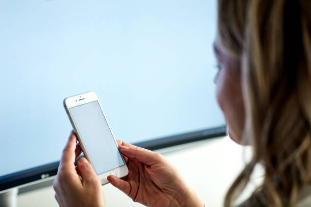 istock Woman holds smartphone with blank screen 1194901136