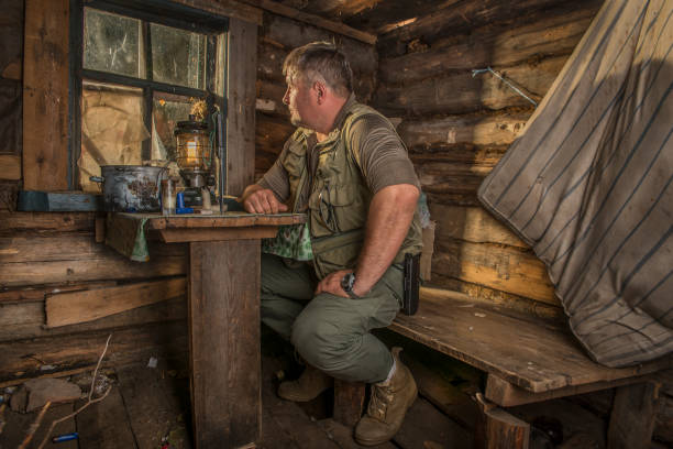 A man in a hunting Lodge at the table.