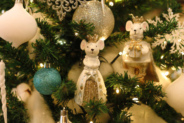 istock artificial Christmas tree decorated with toys in blue and white. Christmas decorations
 mouse king and queen, balls and garland. 1194907071